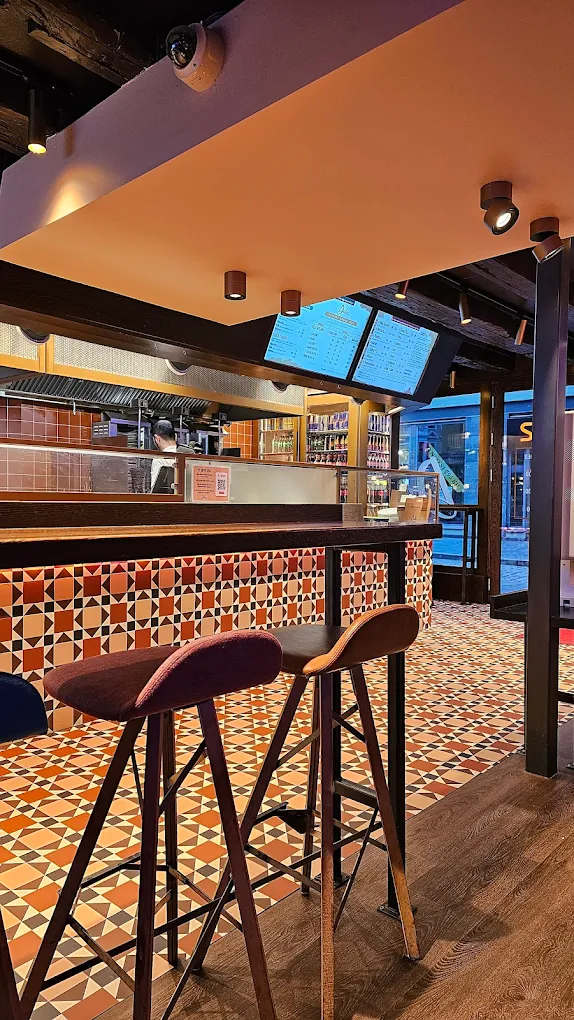 Inside Dalia in Bergen, warm lighting and tile floor